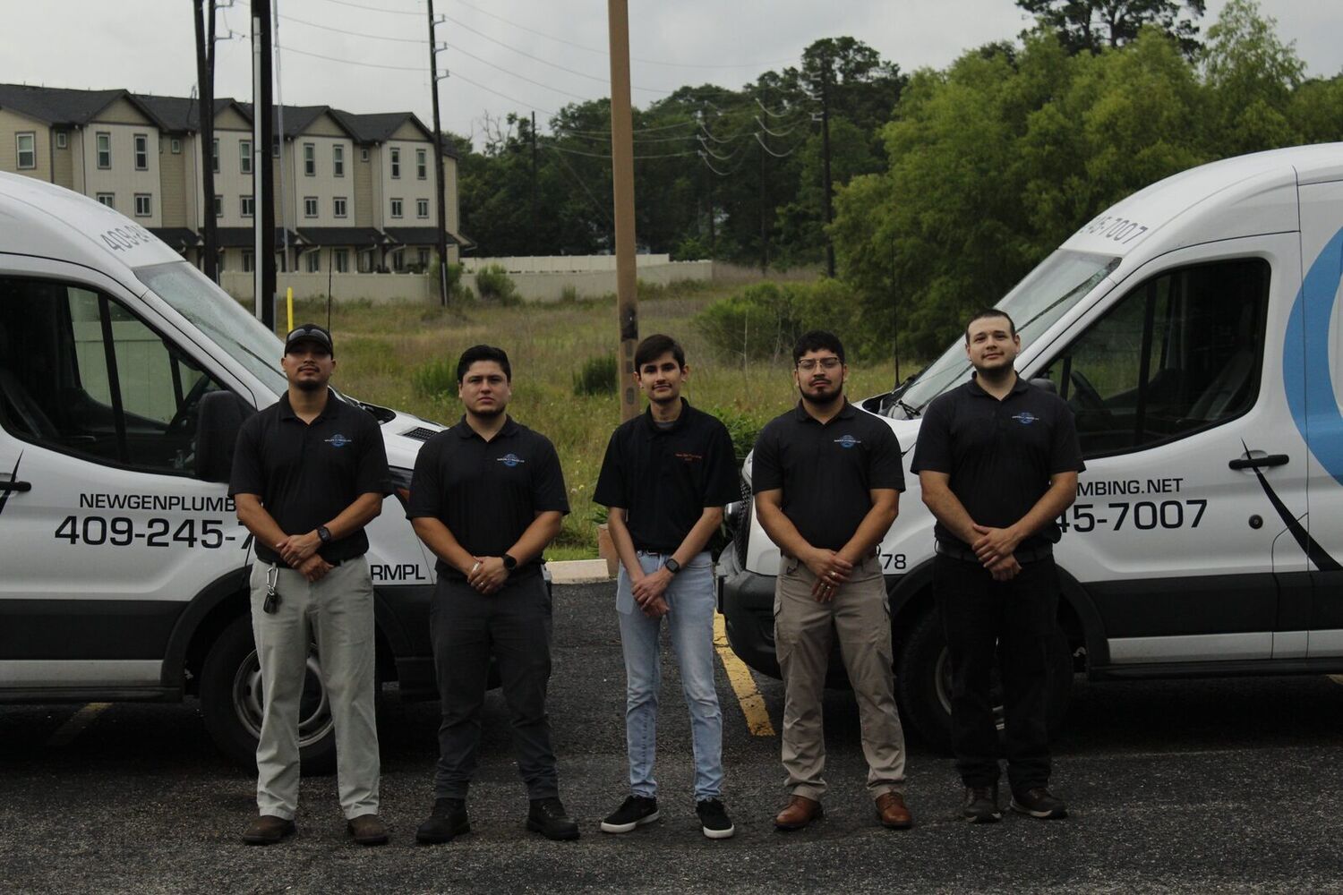 The licensed New Gen Plumbing team posed in front of their service vans in Spring, TX